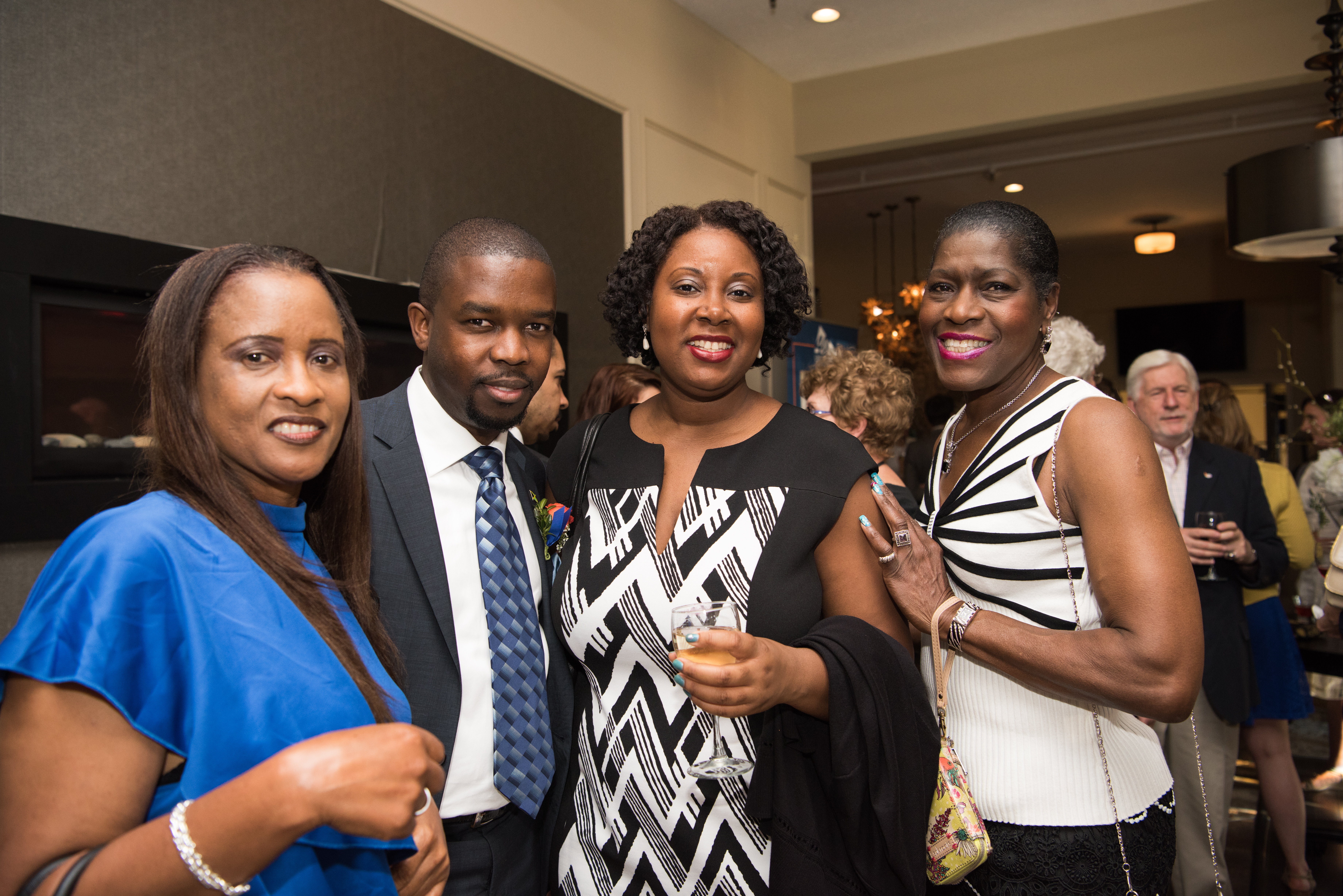 Kyomi Gregory-Martin, send to right, posing with three others at the 2017 40 Under Forty Awards.